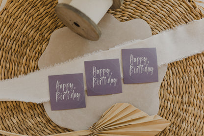 round purple stickers with the inscription &quot;Happy Birthday&quot;