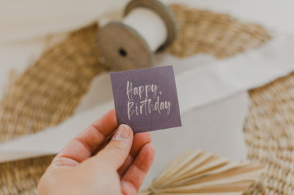 round purple stickers with the inscription &quot;Happy Birthday&quot;