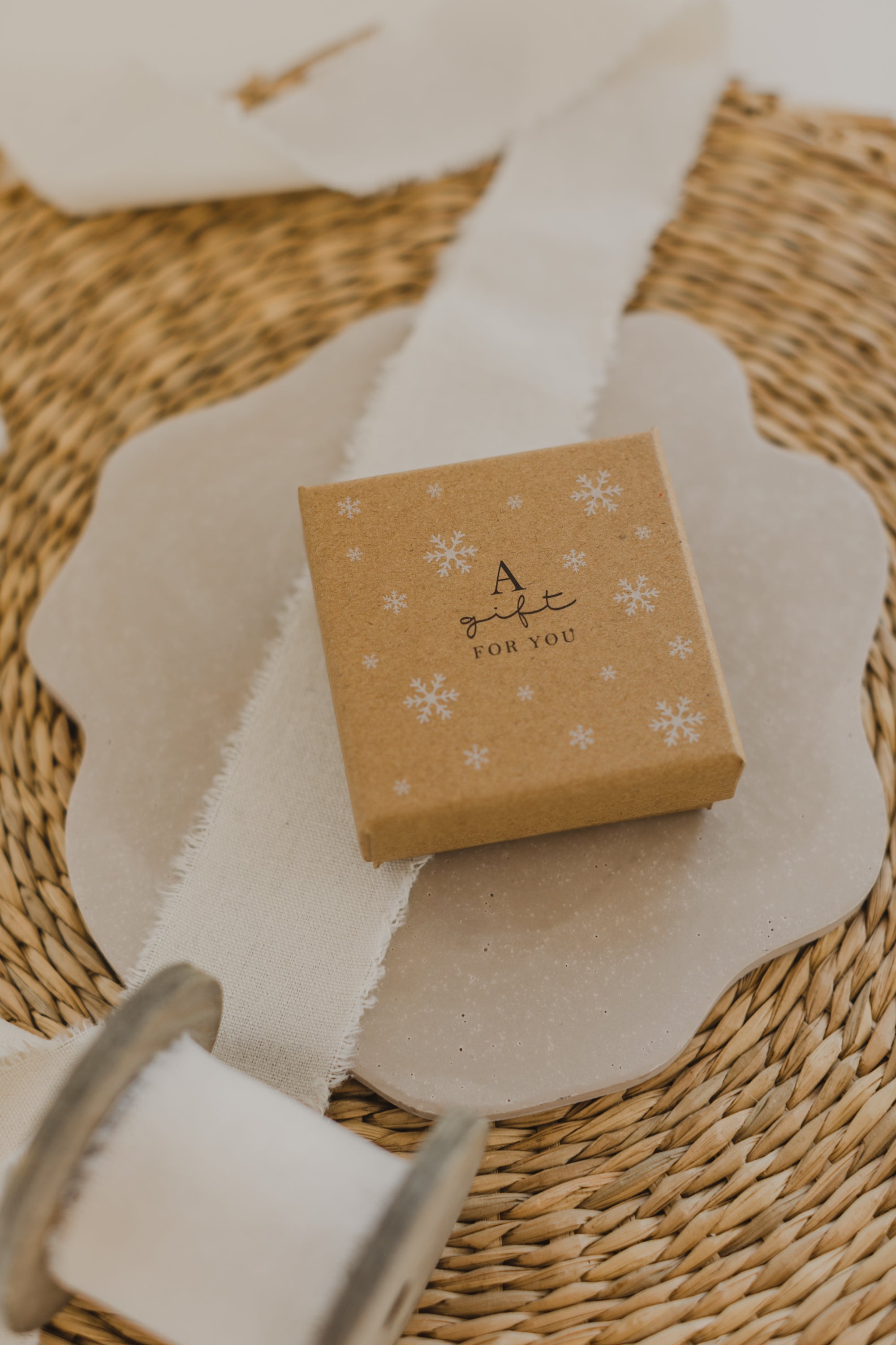 Gift box kraft paper with print &quot;A gift for you&quot; and white snowflakes