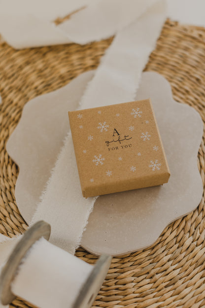 Gift box kraft paper with print &quot;A gift for you&quot; and white snowflakes