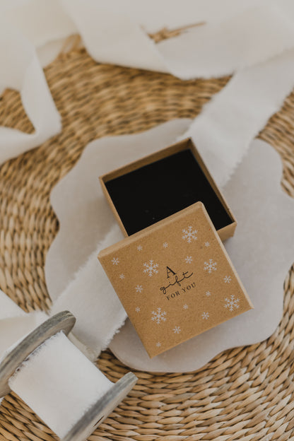 Gift box kraft paper with print &quot;A gift for you&quot; and white snowflakes