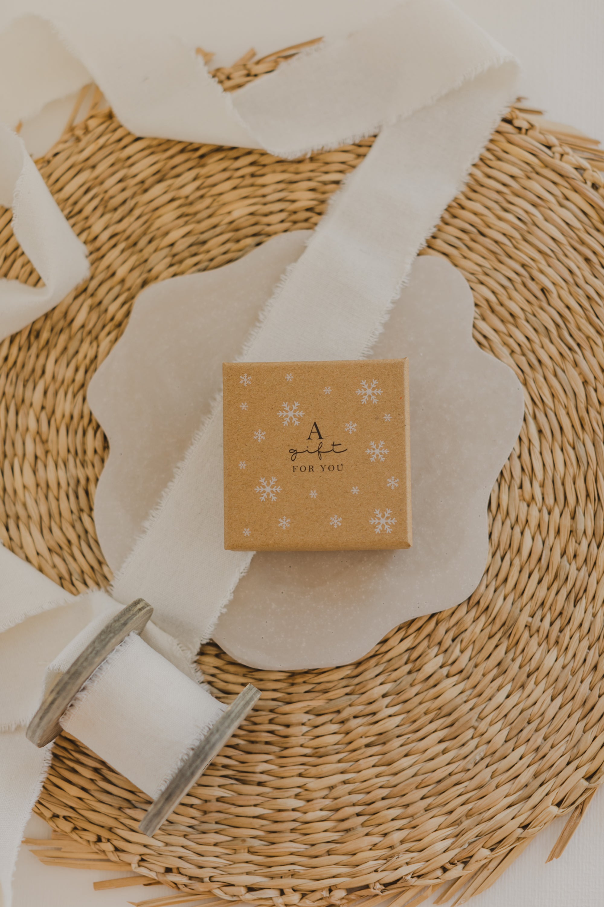 Gift box kraft paper with print &quot;A gift for you&quot; and white snowflakes