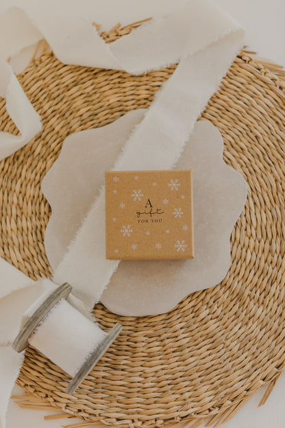 Gift box kraft paper with print &quot;A gift for you&quot; and white snowflakes