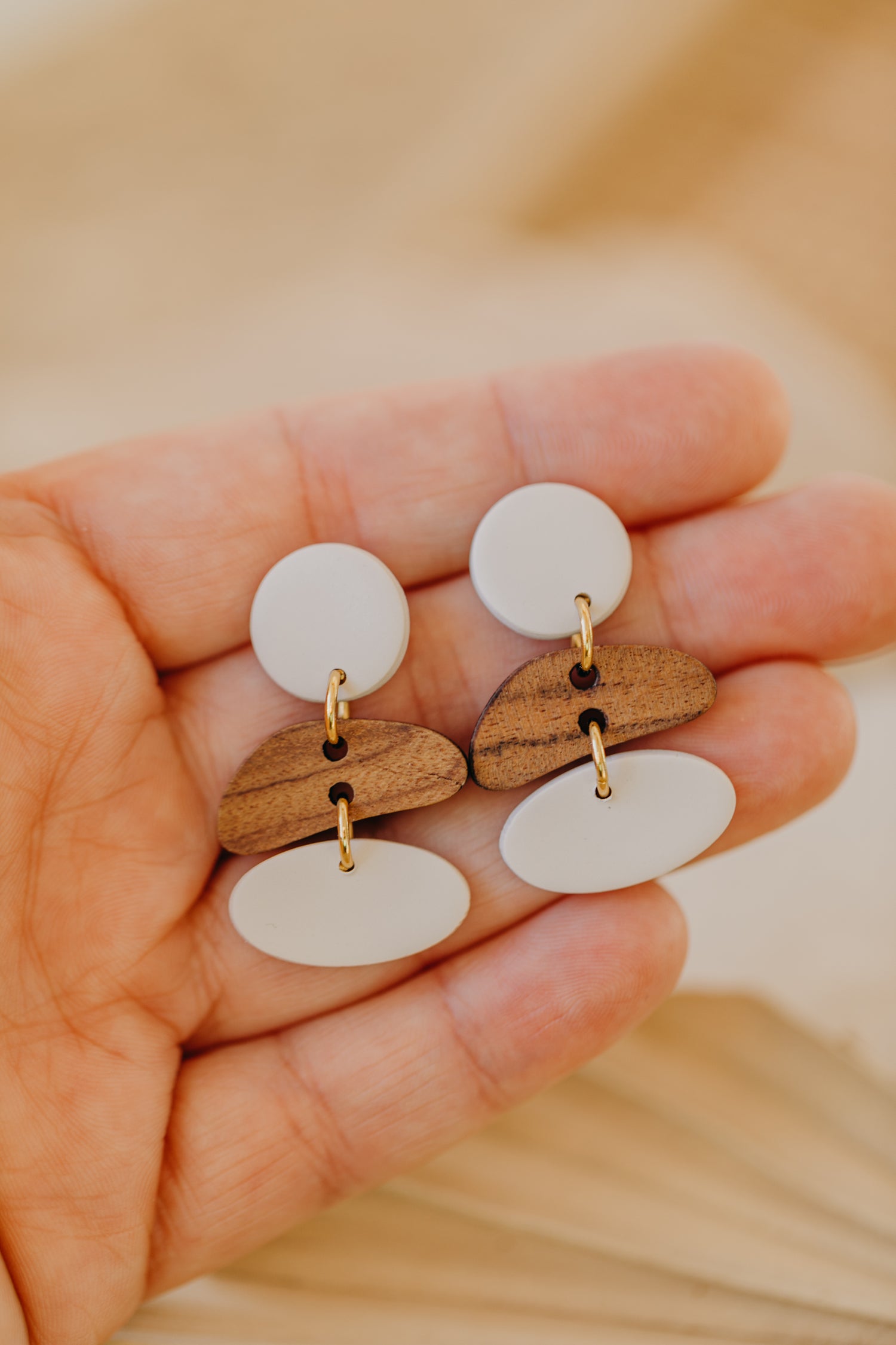 triangular polymer clay earrings in eucalyptus green with rectangular wooden pendant