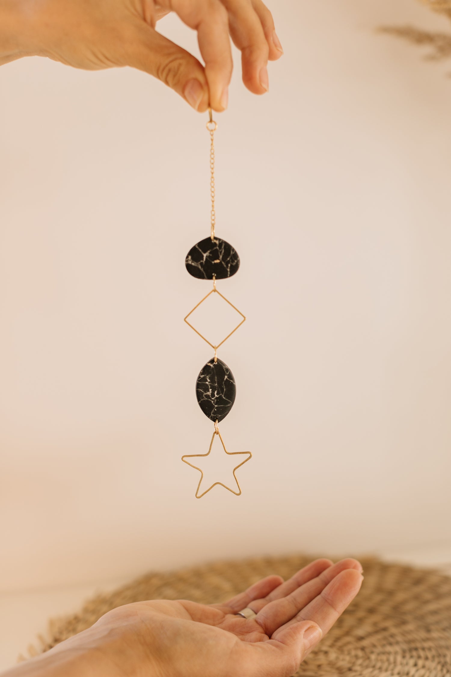 black wall mobile made of polymer clay