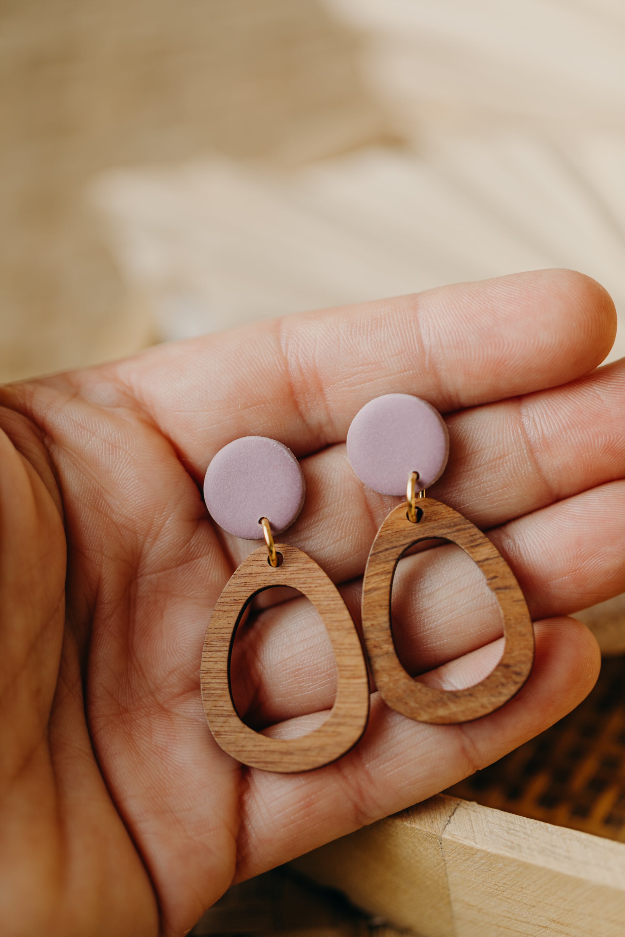 triangular polymer clay earrings in eucalyptus green with rectangular wooden pendant