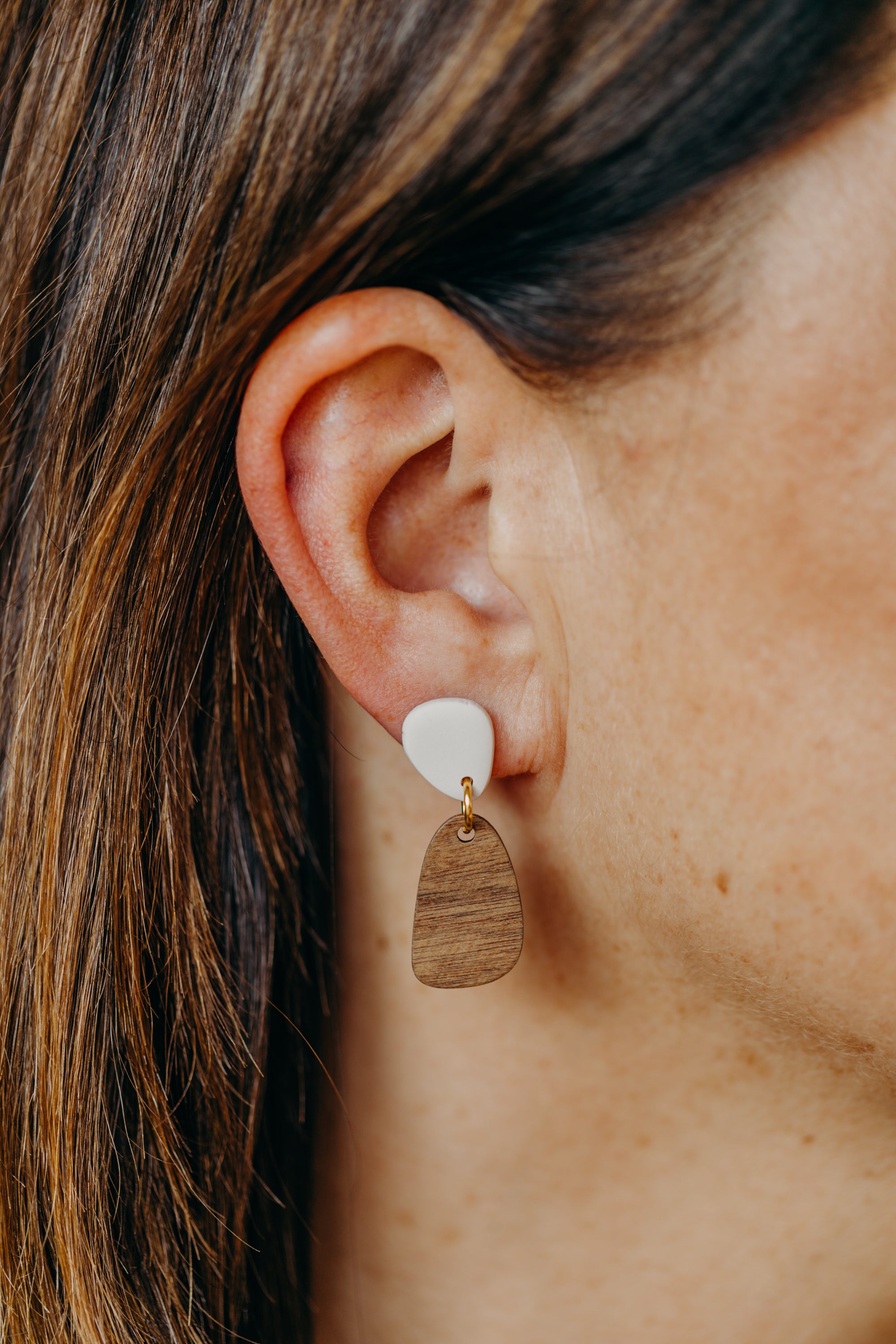 triangular polymer clay earrings in eucalyptus green with rectangular wooden pendant