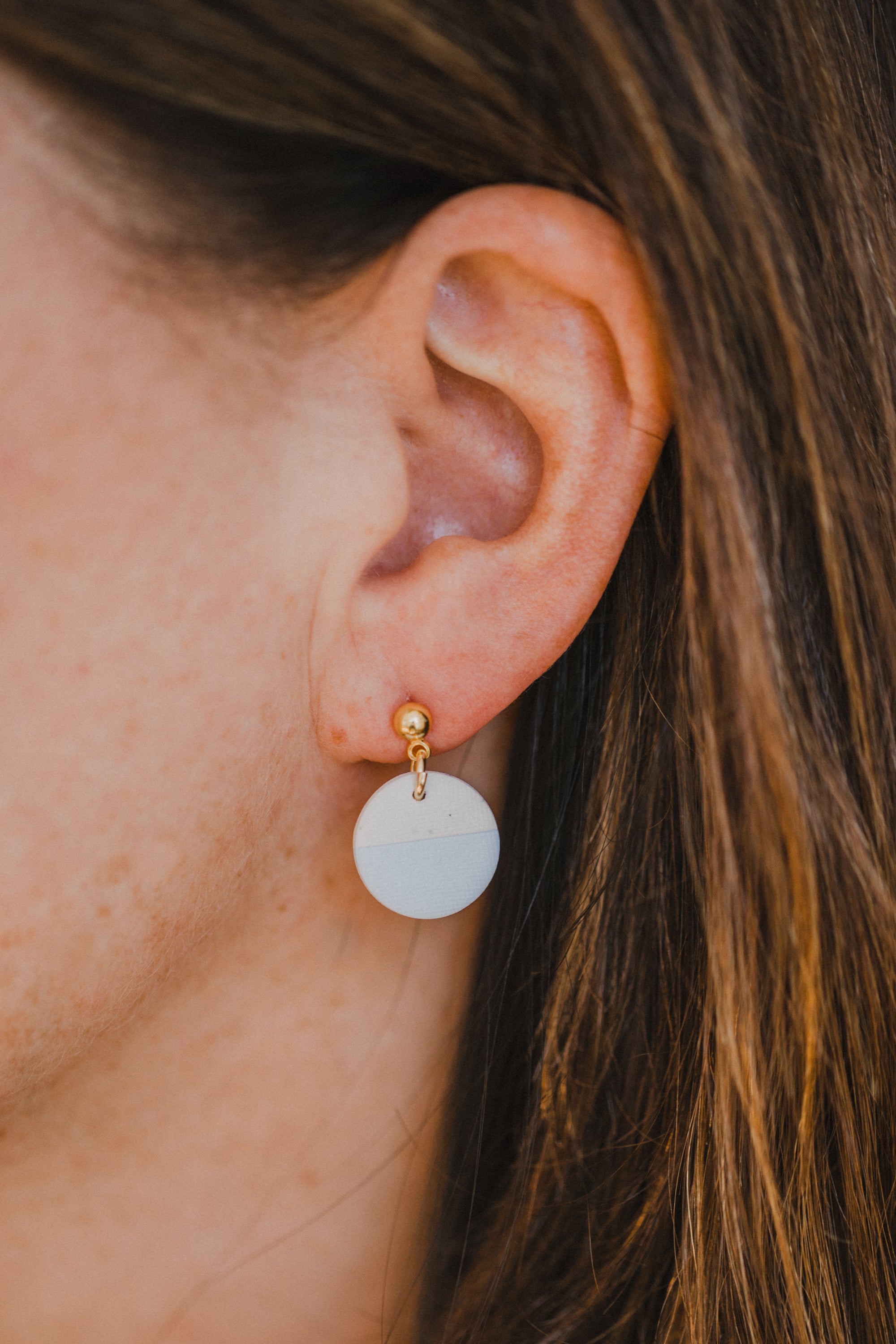 round two-tone earrings made of polymer clay in pastel colors