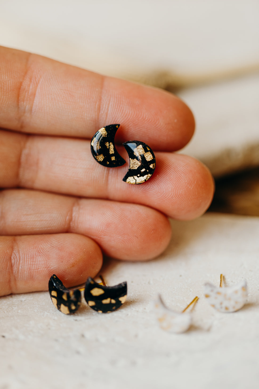 small moon earrings made of polymer clay with gold leaf