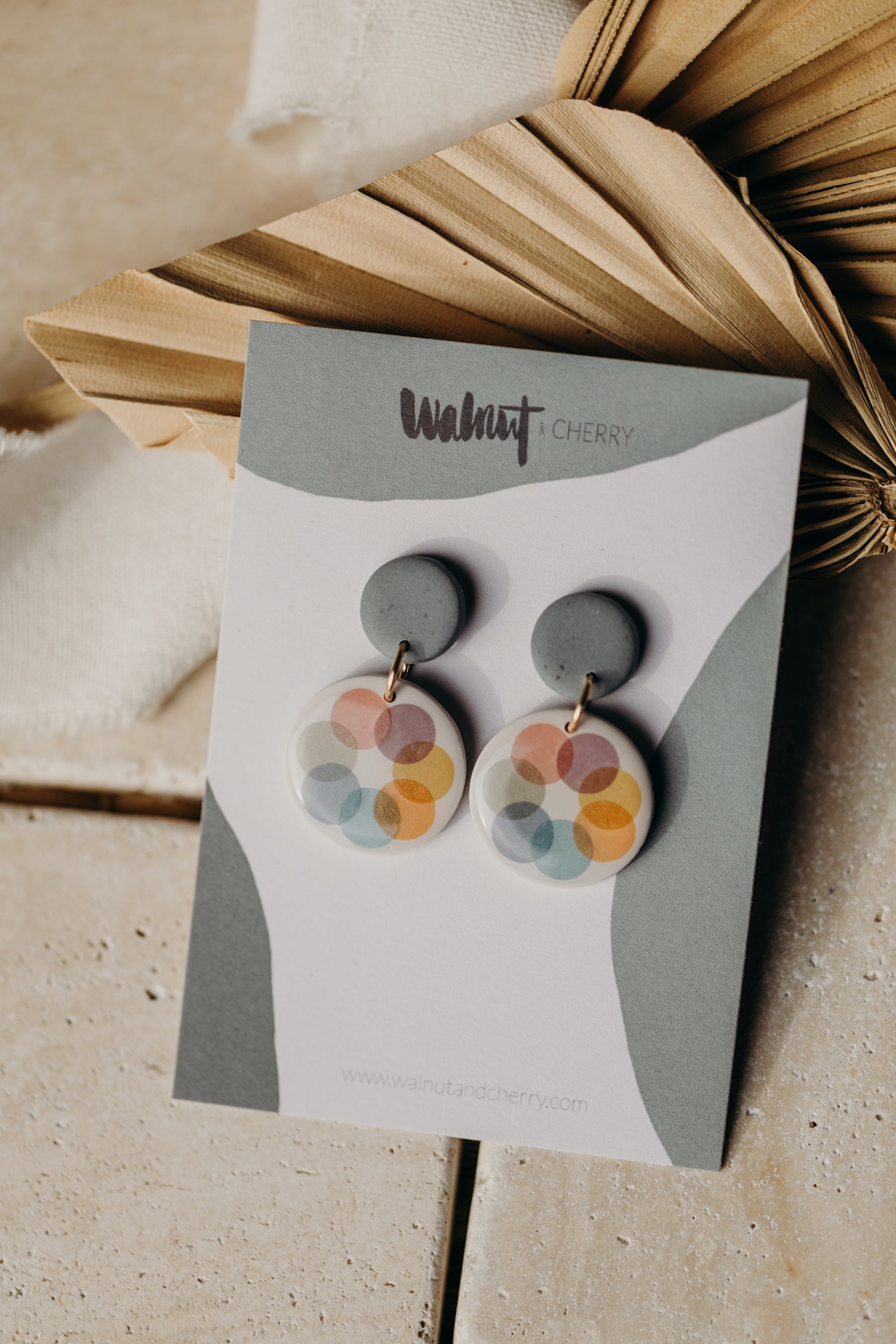 round blue polymer clay earrings with colorful dots