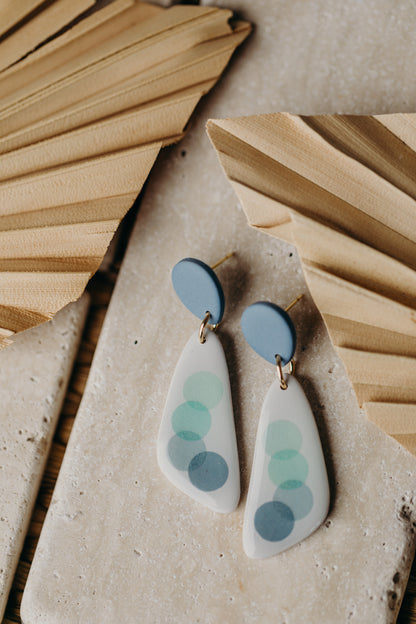 elongated blue polymer clay earrings with blue dots