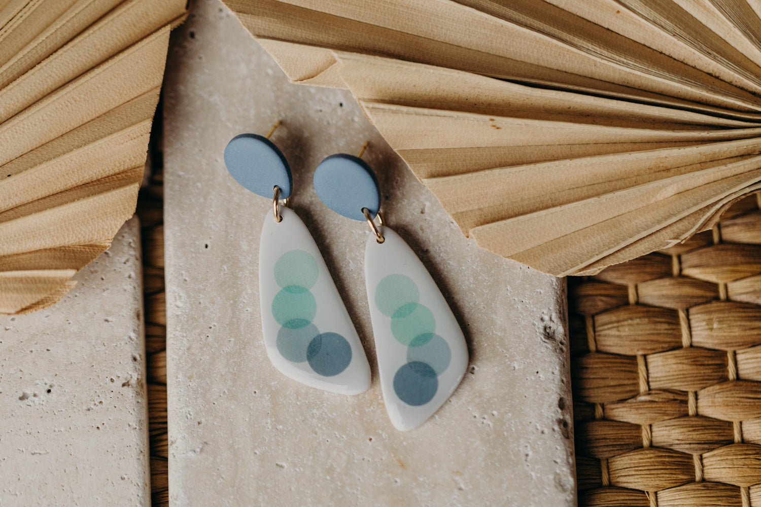 elongated blue polymer clay earrings with blue dots