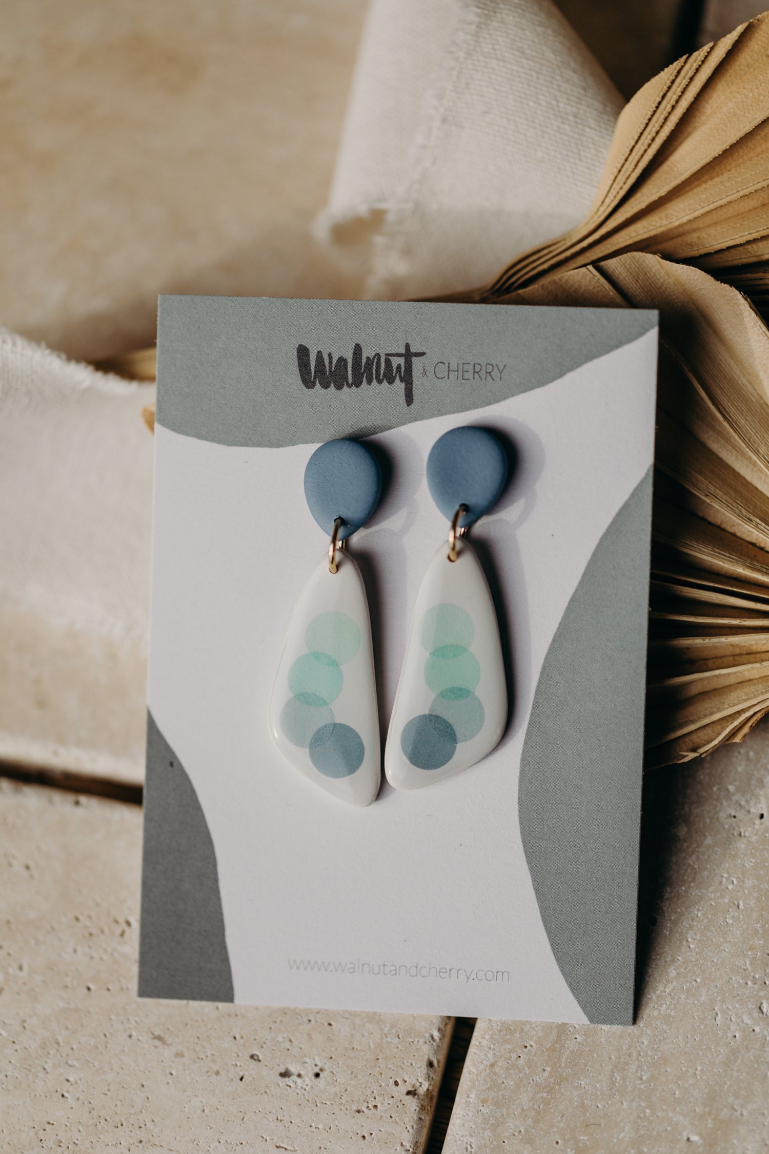 elongated blue polymer clay earrings with blue dots