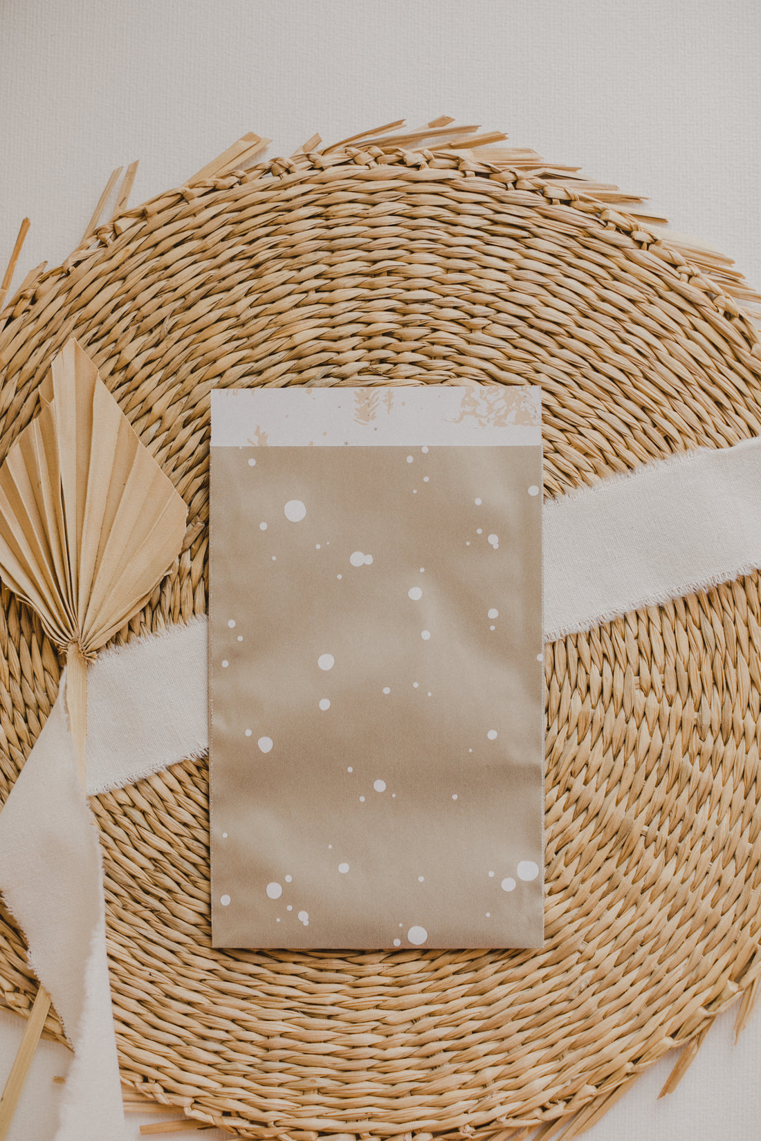 large golden paper bag with white dots