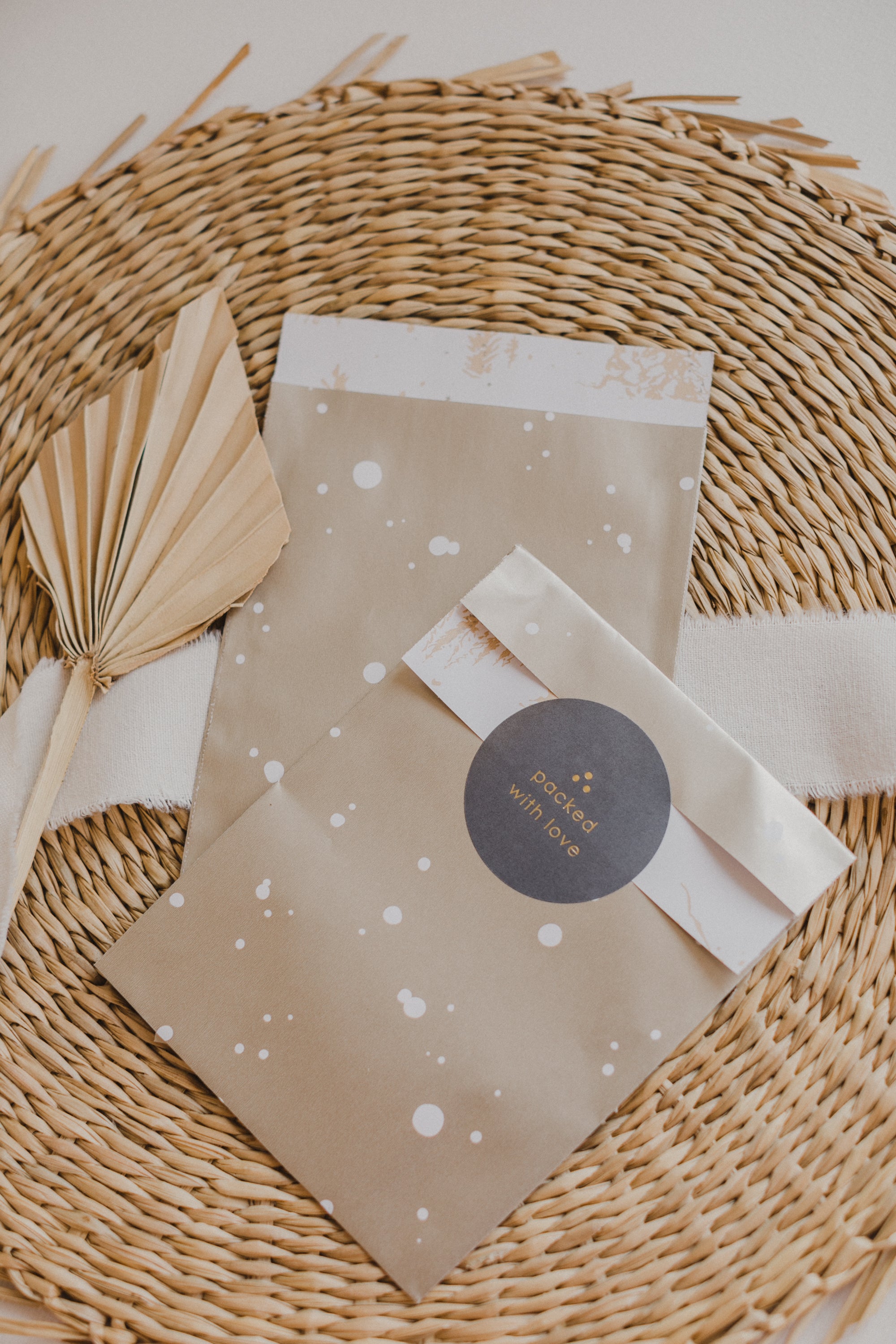 large golden paper bag with white dots