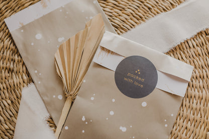 large golden paper bag with white dots