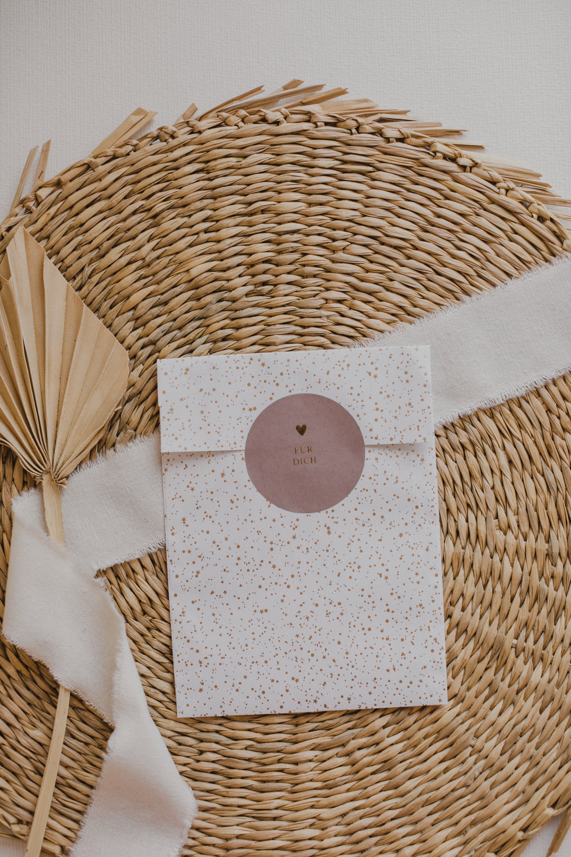 large white paper bag with golden dots