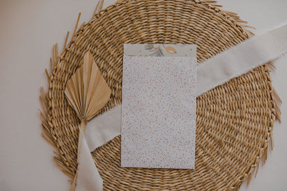 large white paper bag with golden dots