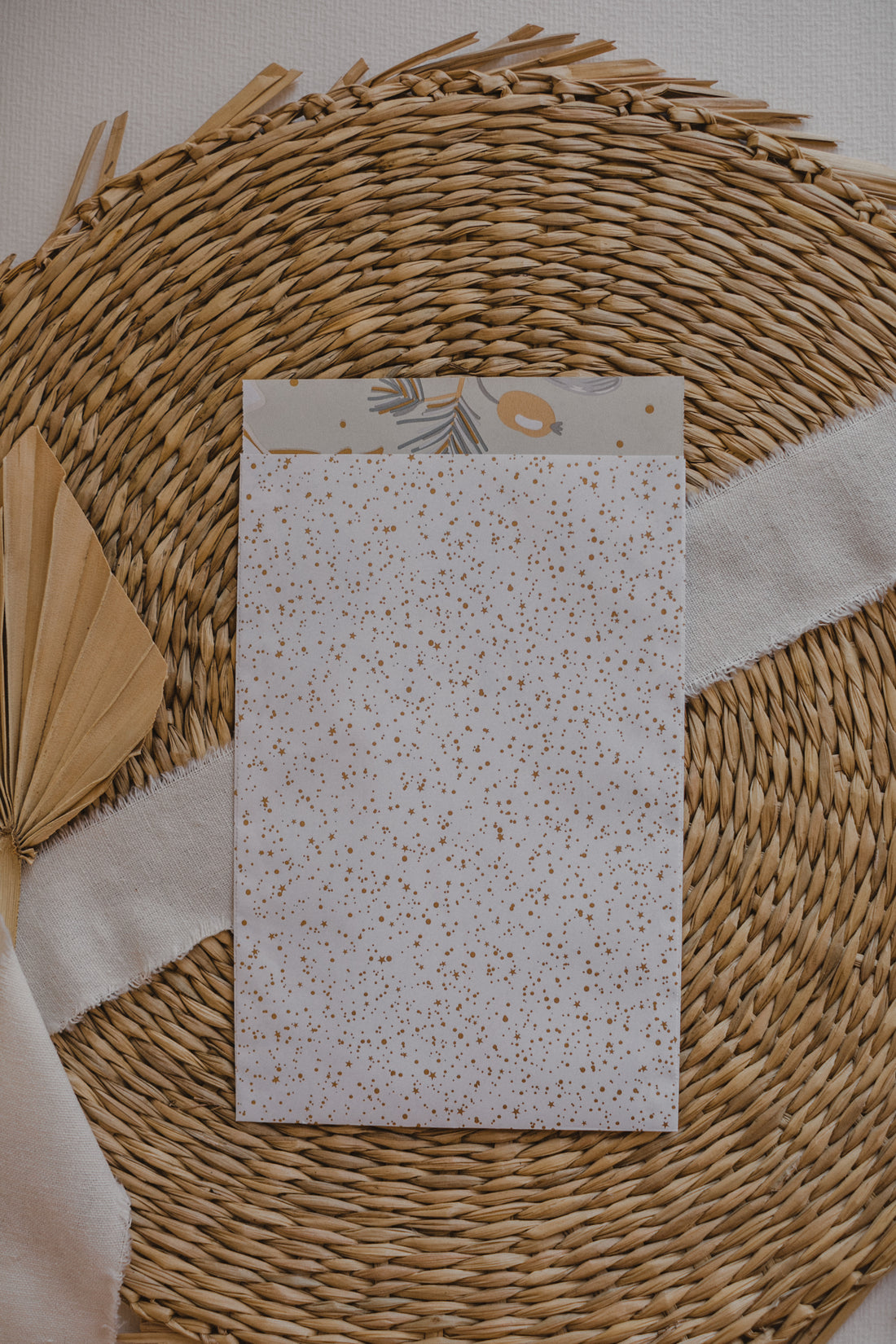 large white paper bag with golden dots