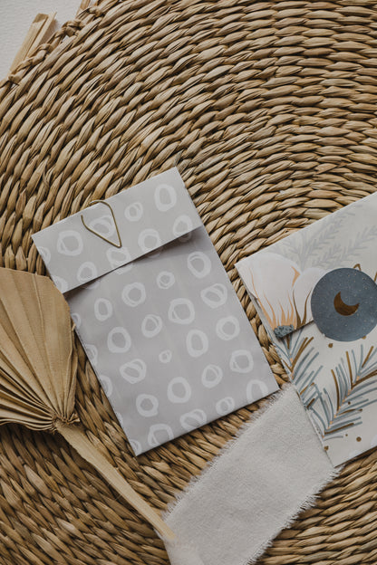 small gray paper bag with white circles