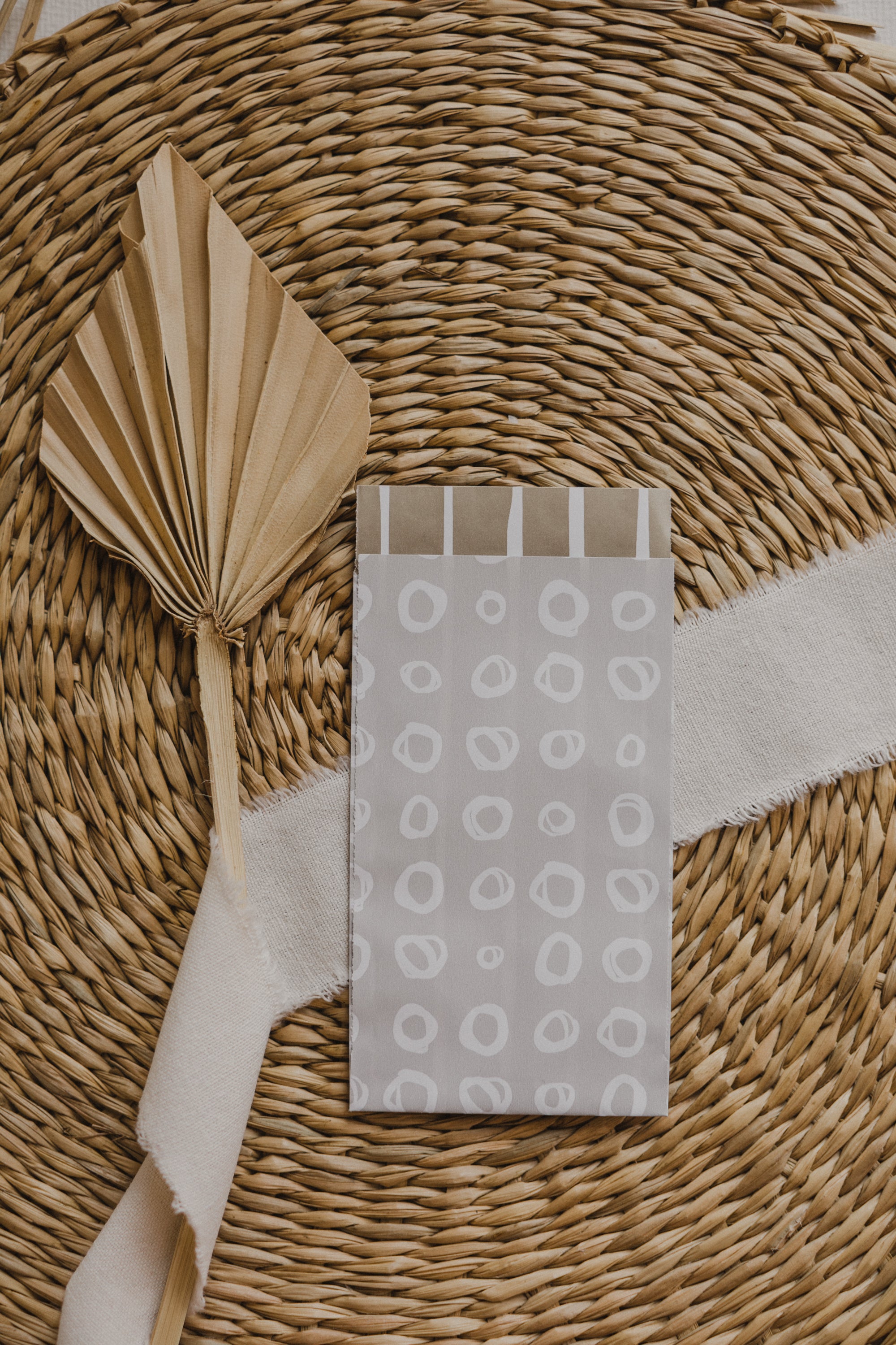 small gray paper bag with white circles