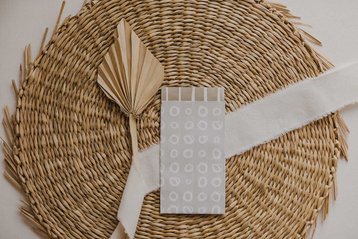 small gray paper bag with white circles