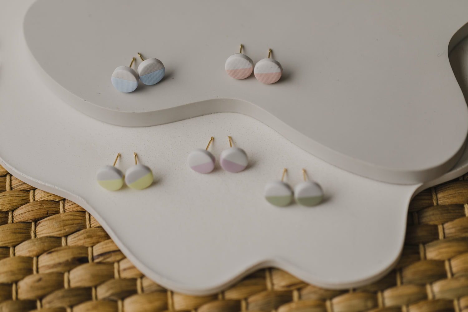 small round two-tone earrings made of polymer clay in pastel colors