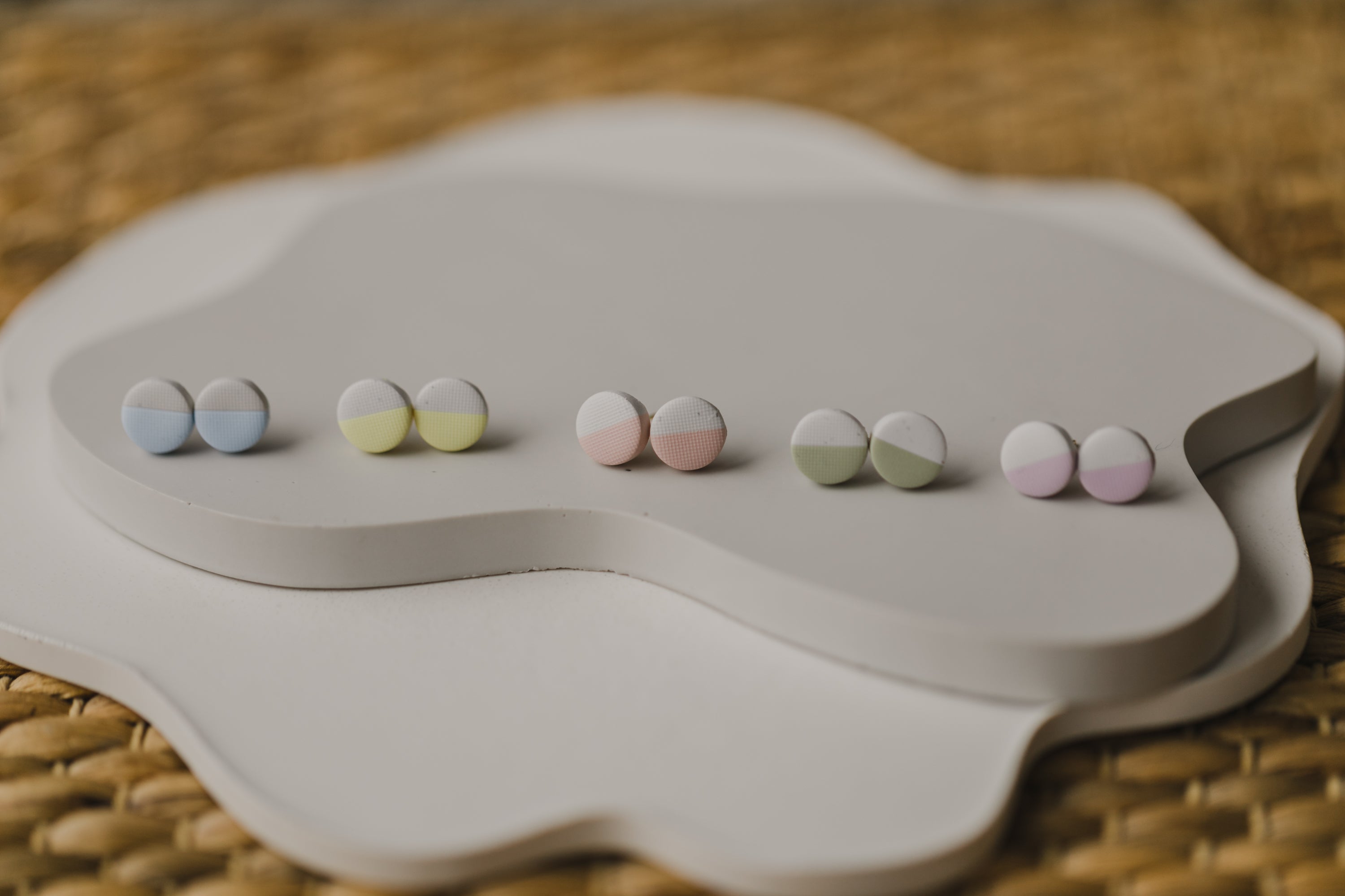 small round two-tone earrings made of polymer clay in pastel colors