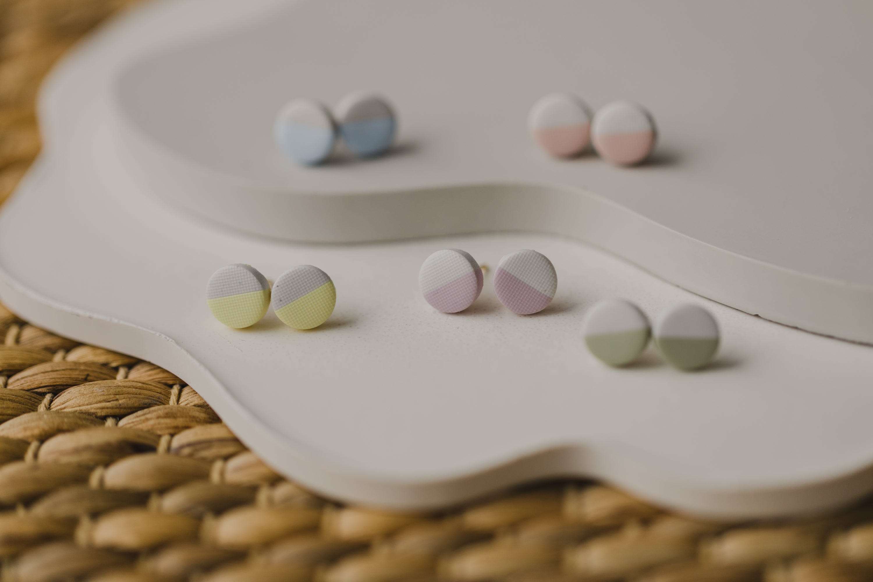 small round two-tone earrings made of polymer clay in pastel colors