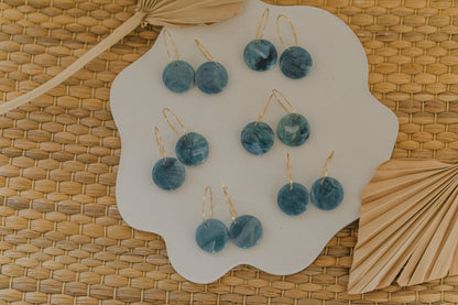 Hoop earrings with round polymer clay pendant and leaf