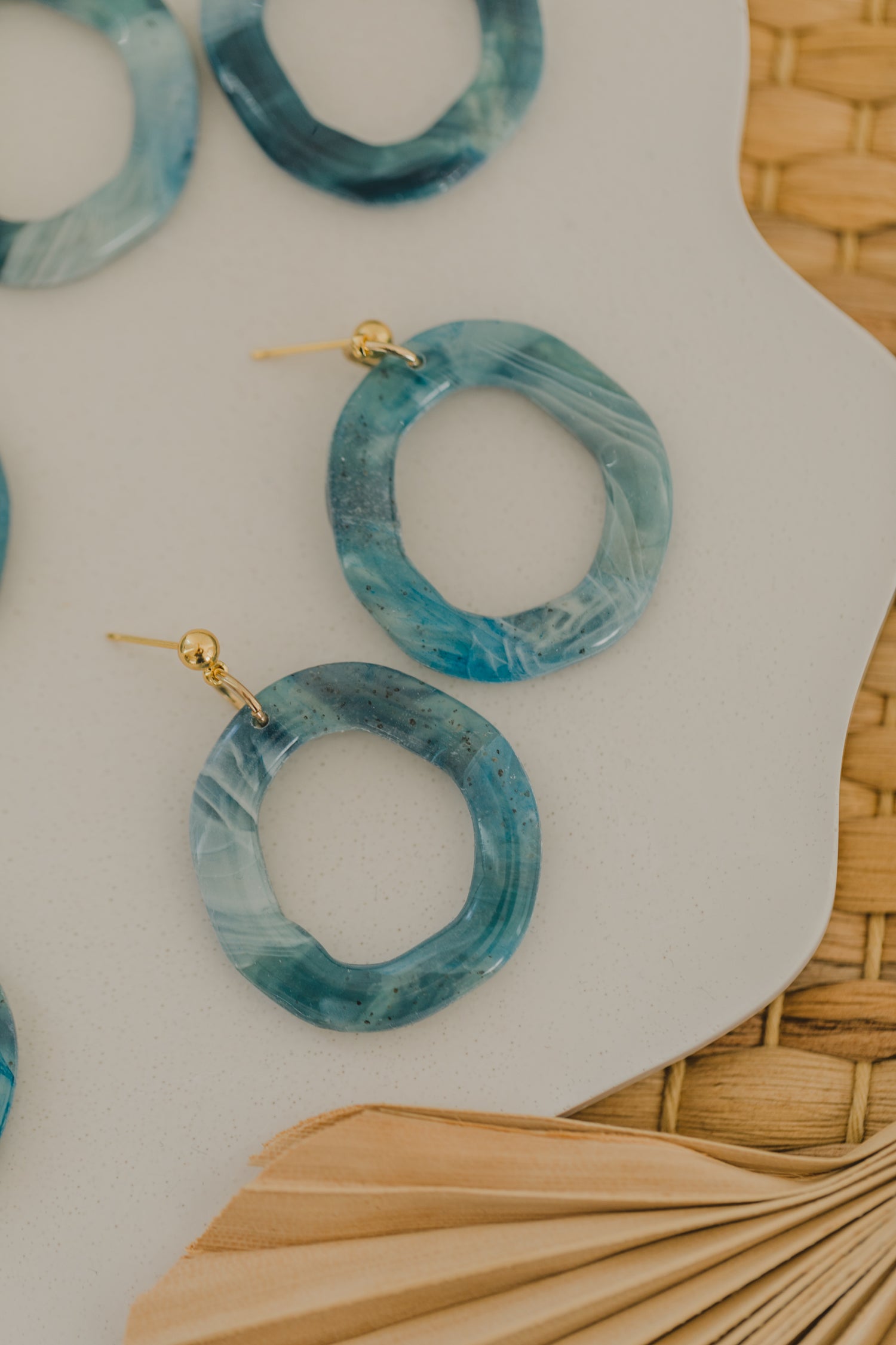 Hoop earrings with round polymer clay pendant and leaf