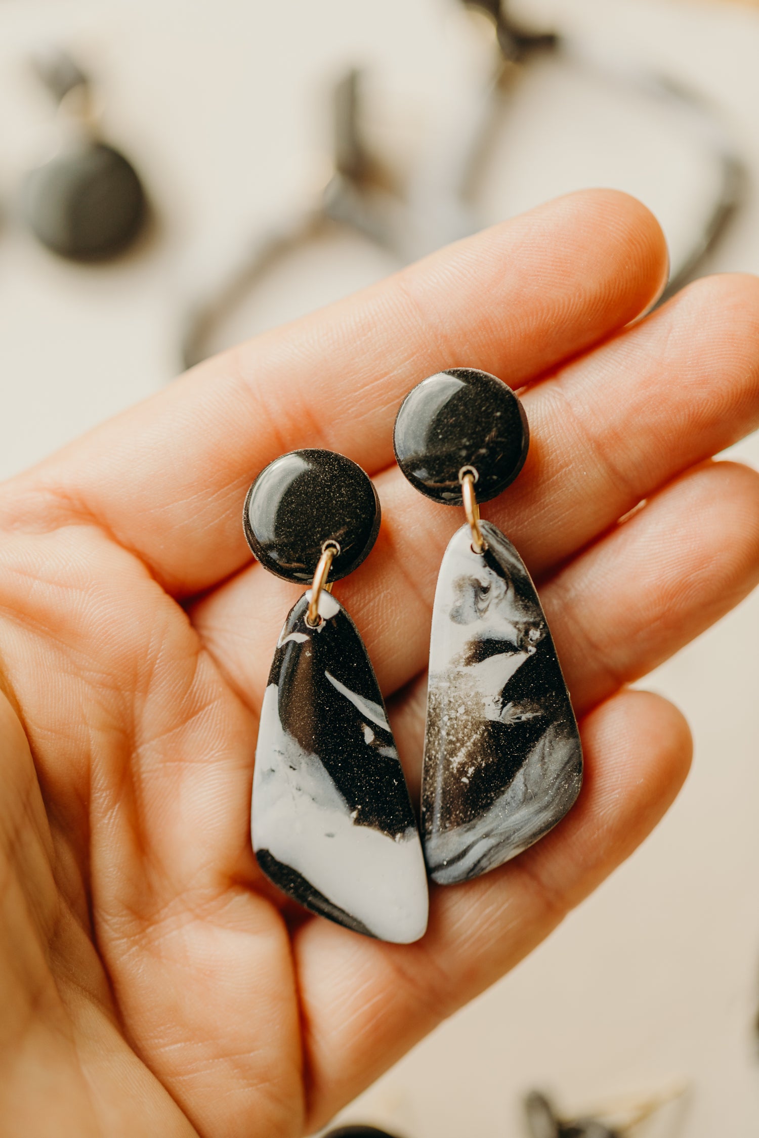 black polymer clay earrings with white pattern