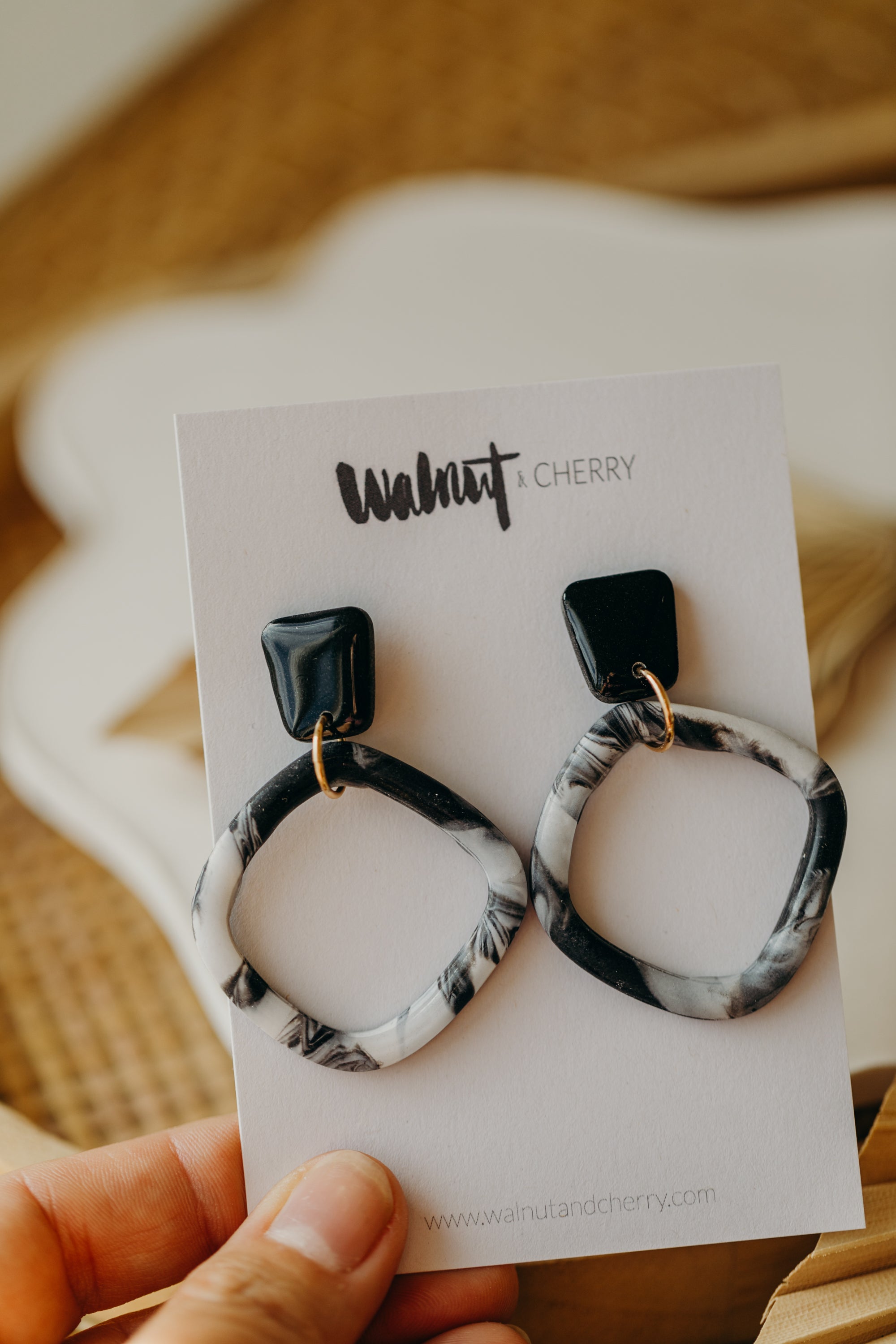 black polymer clay earrings with white pattern