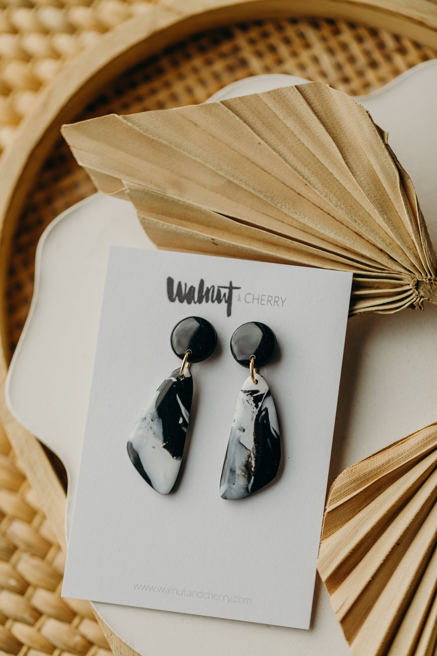 black polymer clay earrings with white pattern