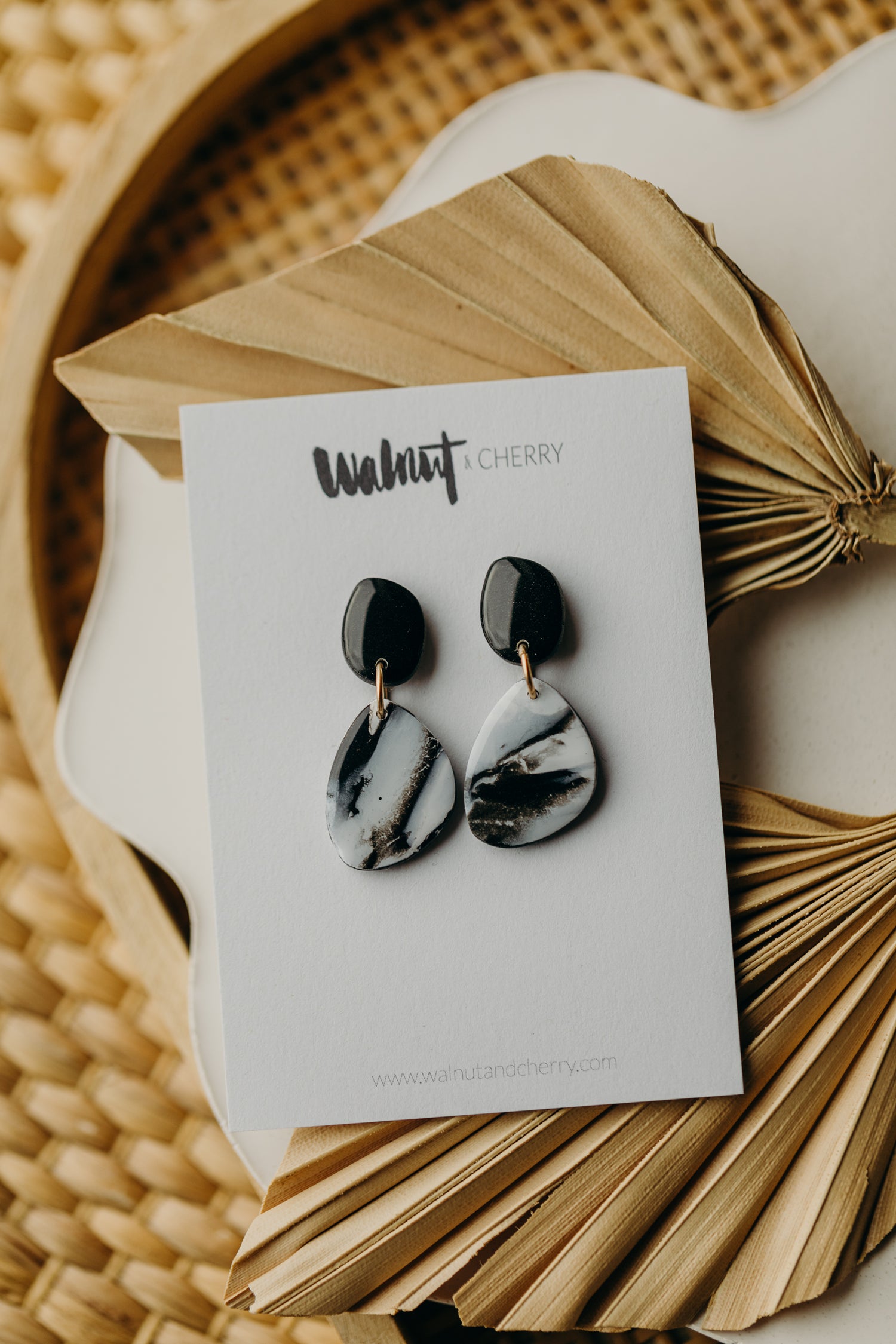 black polymer clay earrings with white pattern