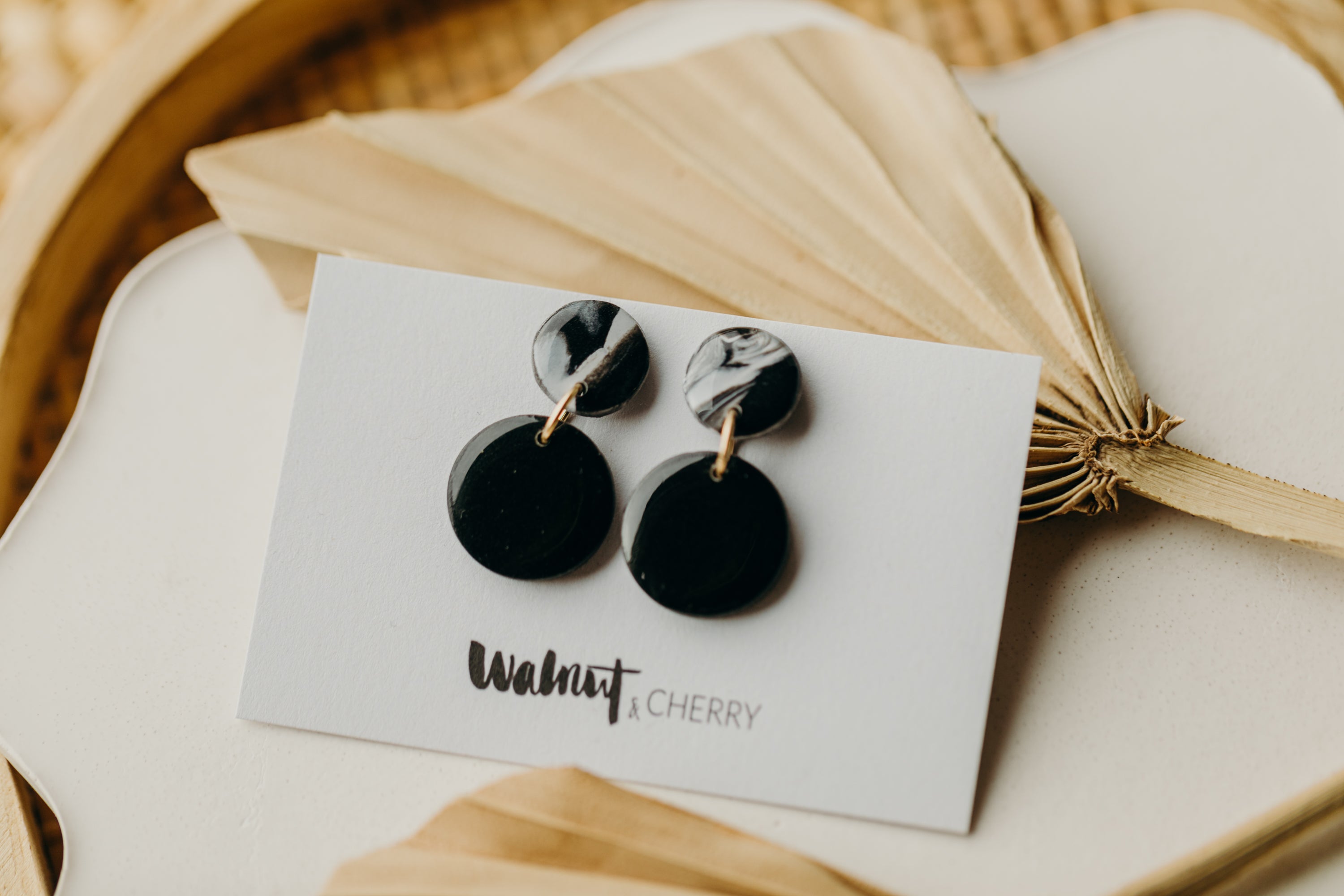 black polymer clay earrings with white pattern