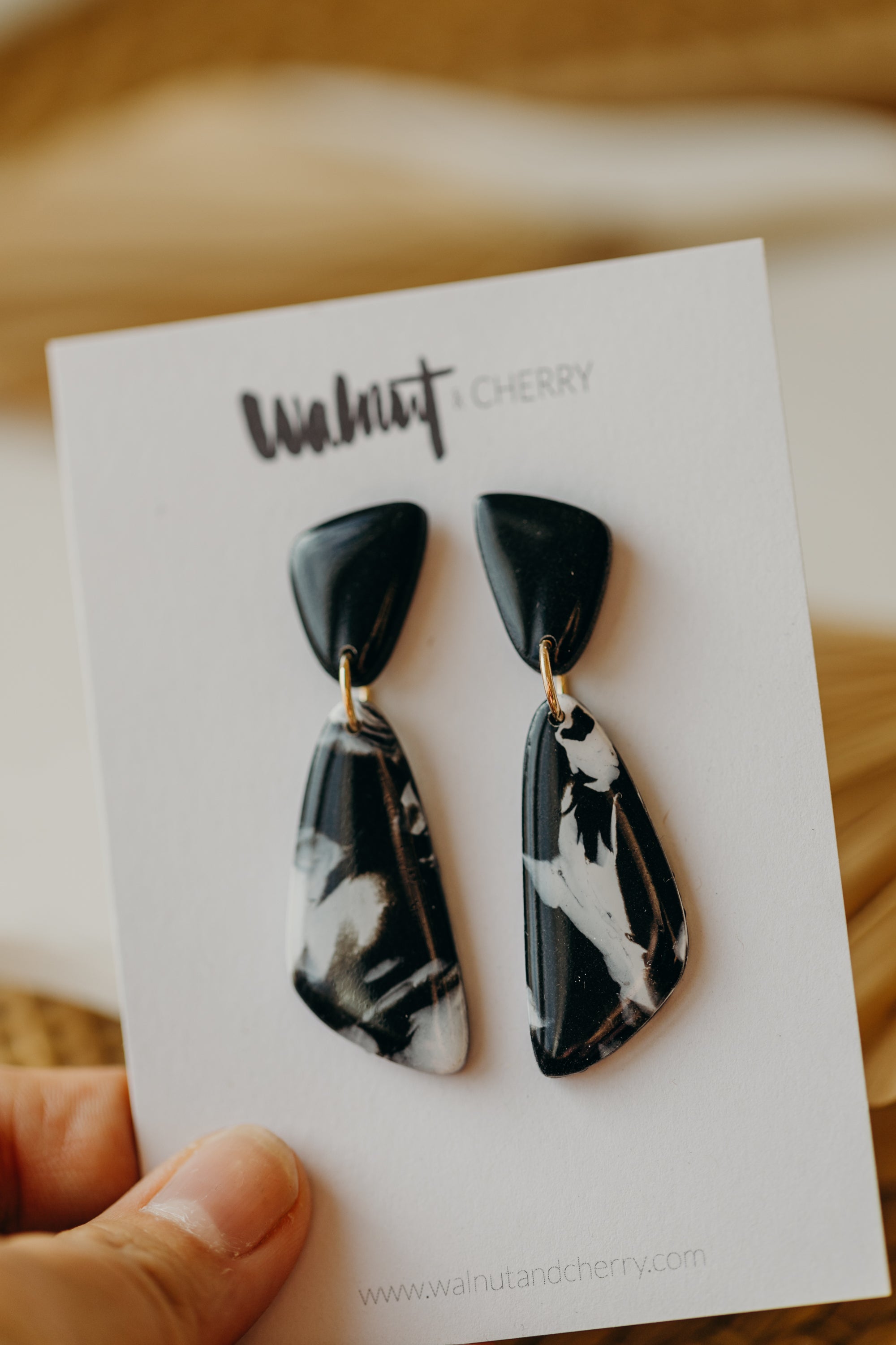 black polymer clay earrings with white pattern