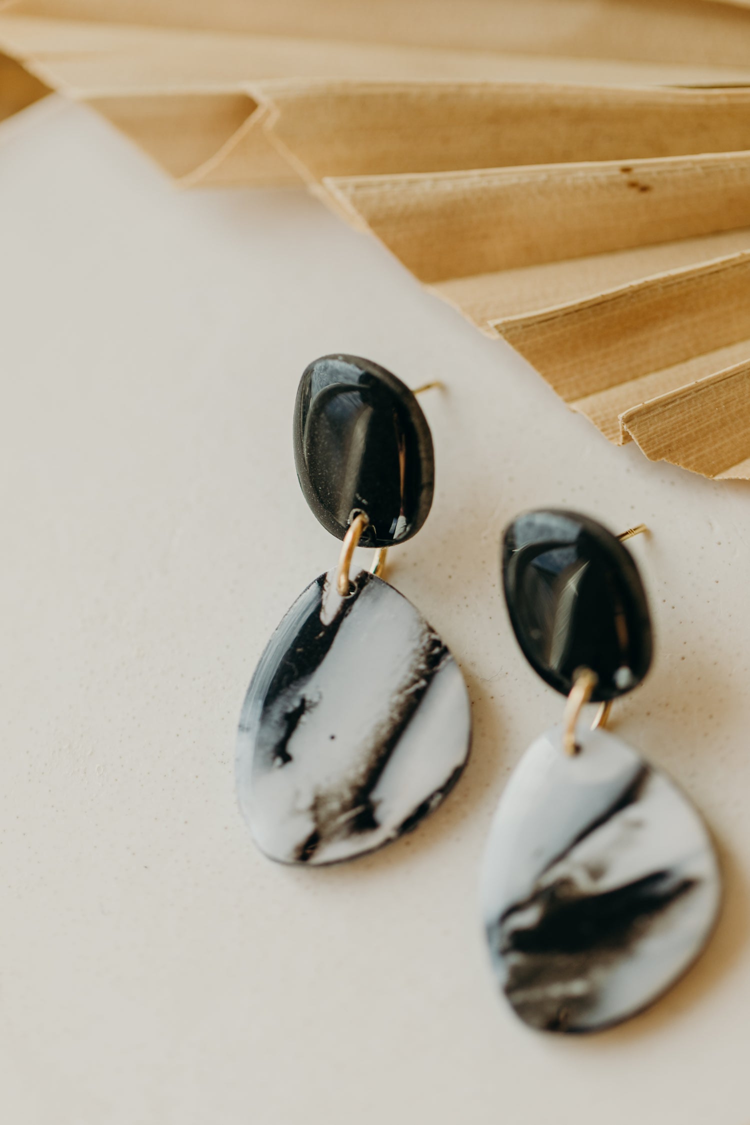 black polymer clay earrings with white pattern