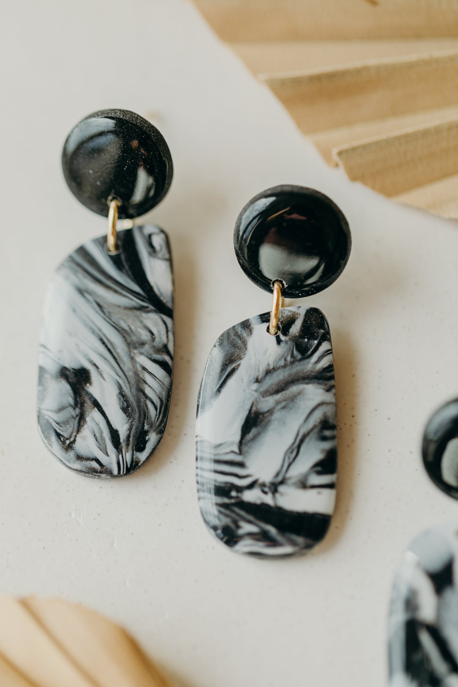 black polymer clay earrings with white pattern