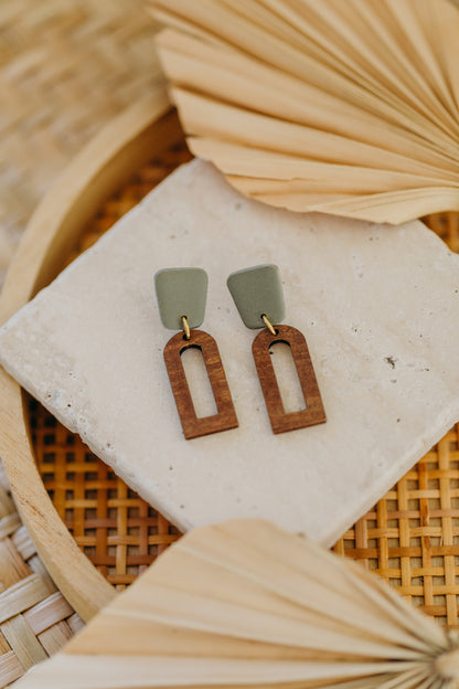 triangular polymer clay earrings in eucalyptus green with rectangular wooden pendant