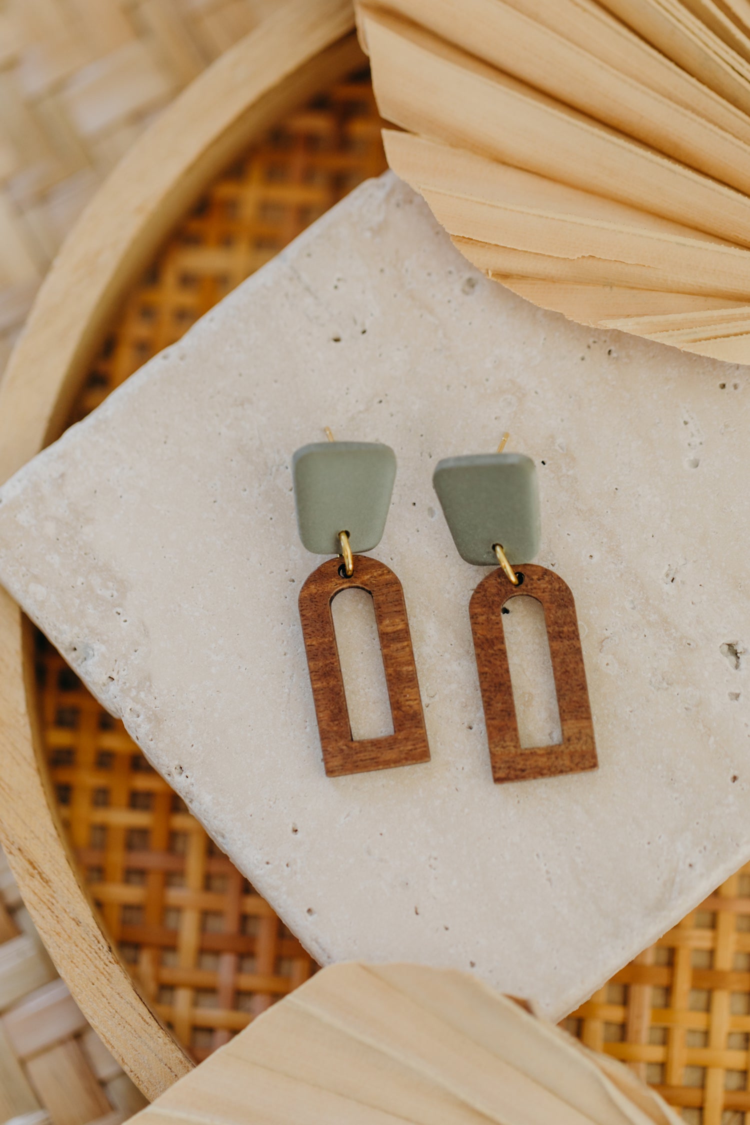 triangular polymer clay earrings in eucalyptus green with rectangular wooden pendant