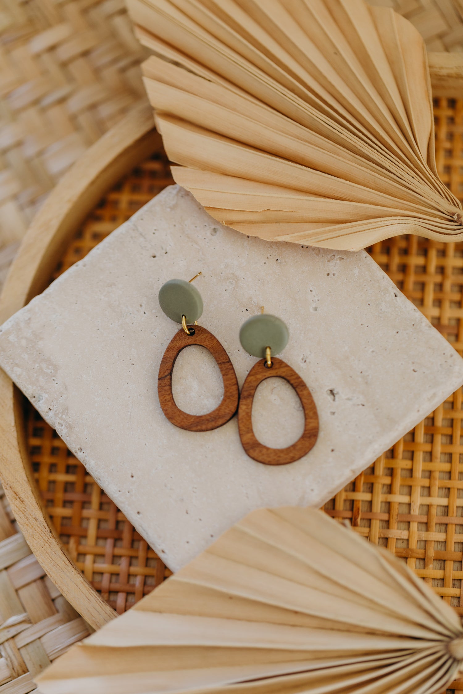 triangular polymer clay earrings in eucalyptus green with rectangular wooden pendant