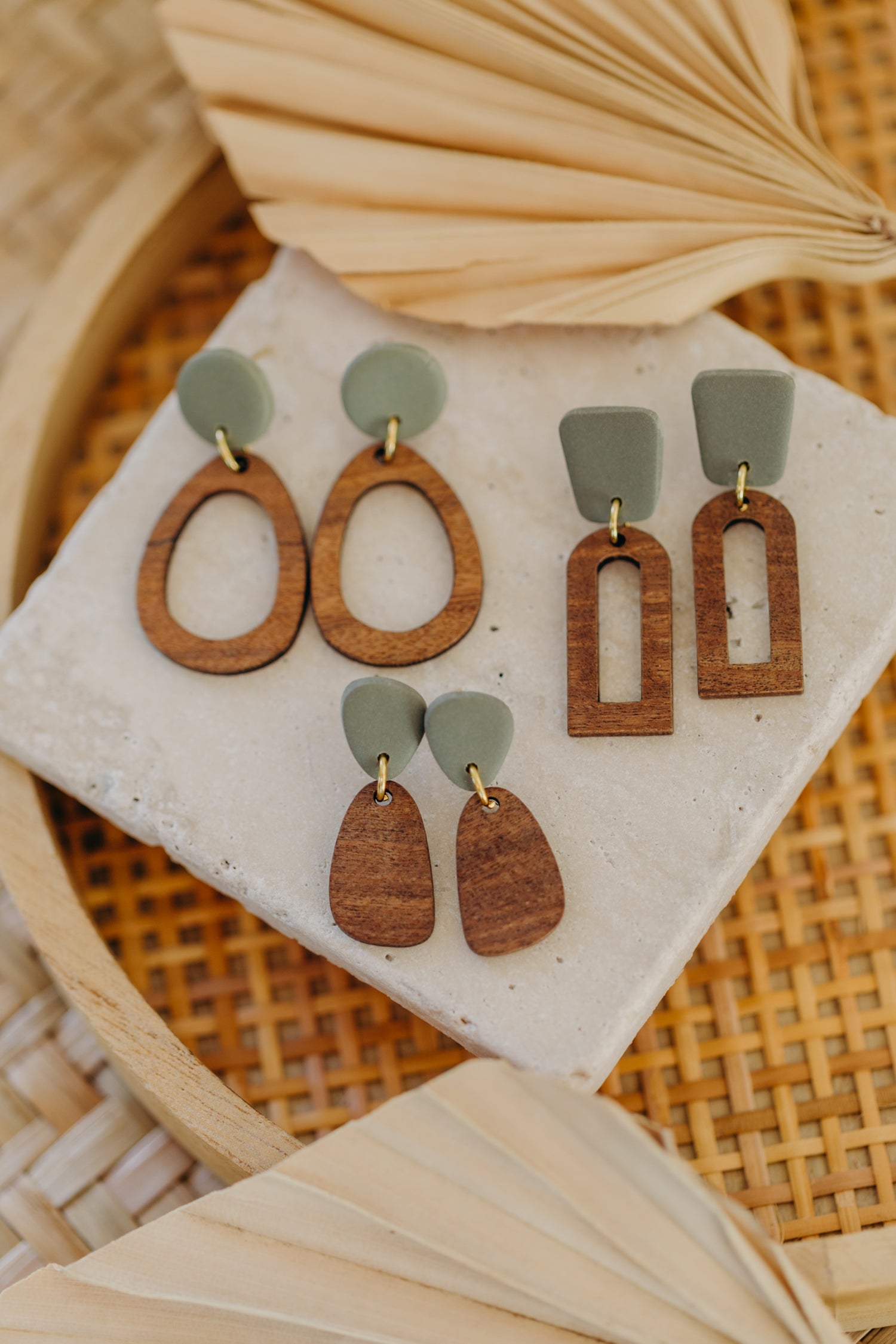 triangular polymer clay earrings in eucalyptus green with rectangular wooden pendant