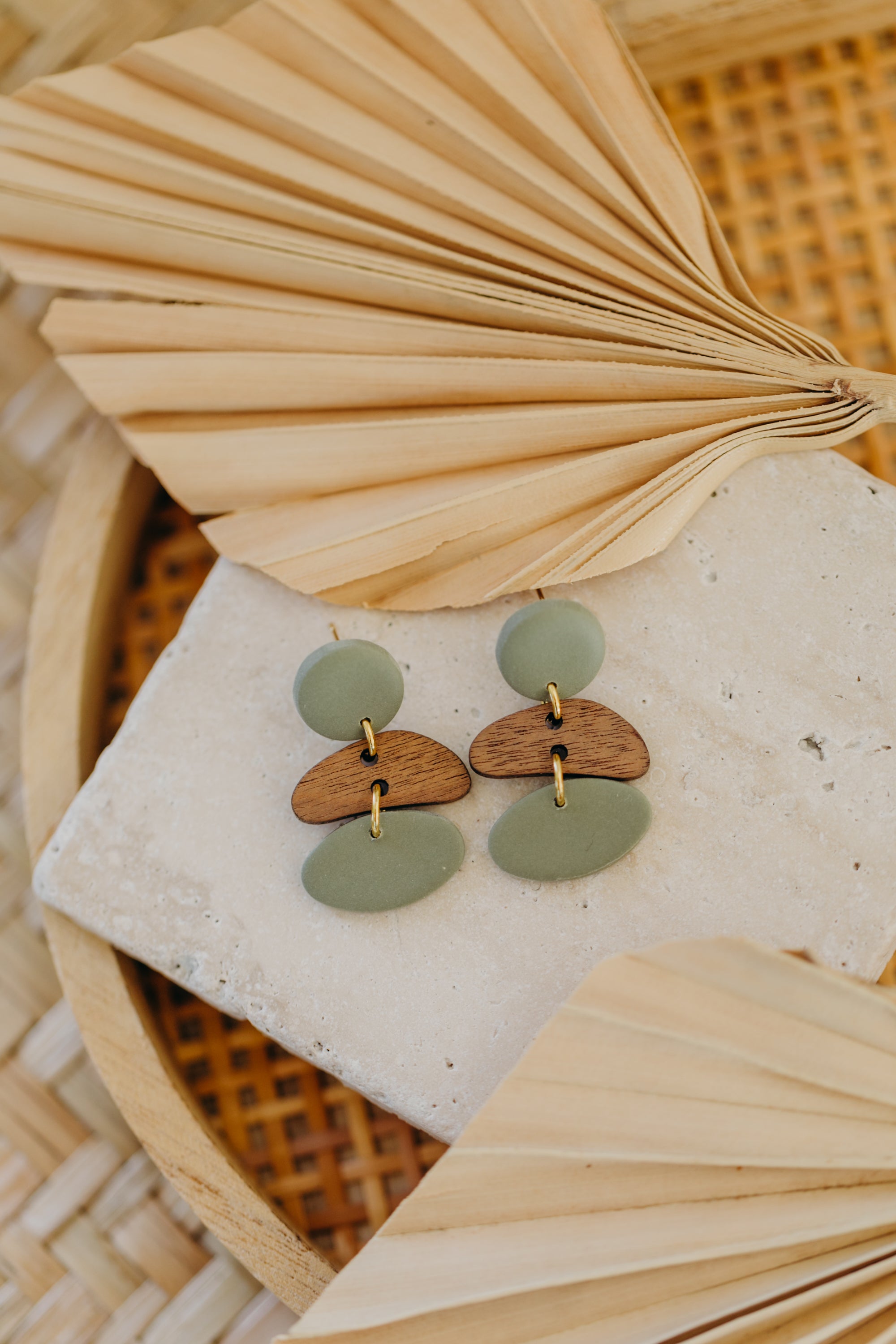 triangular polymer clay earrings in eucalyptus green with rectangular wooden pendant