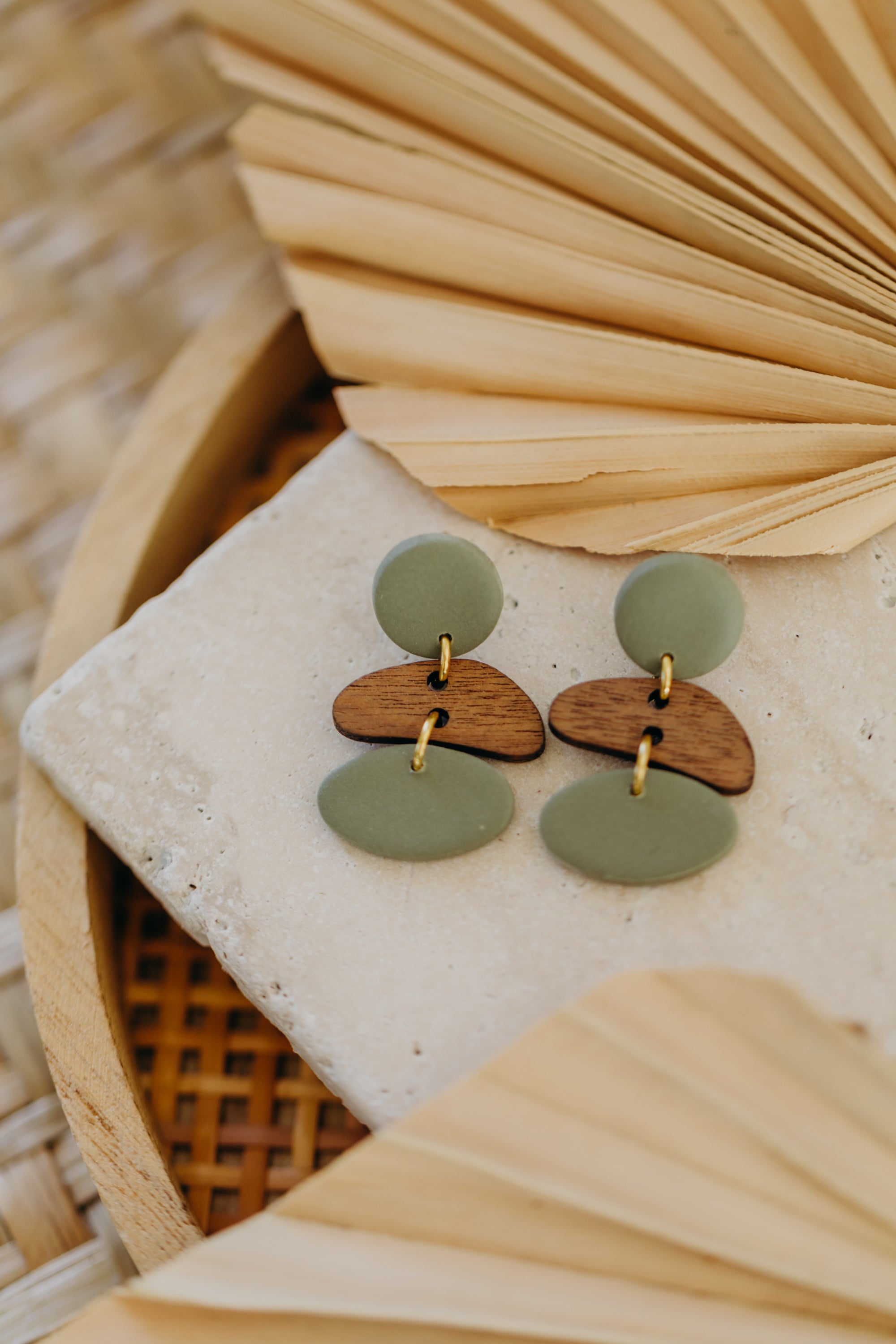 triangular polymer clay earrings in eucalyptus green with rectangular wooden pendant