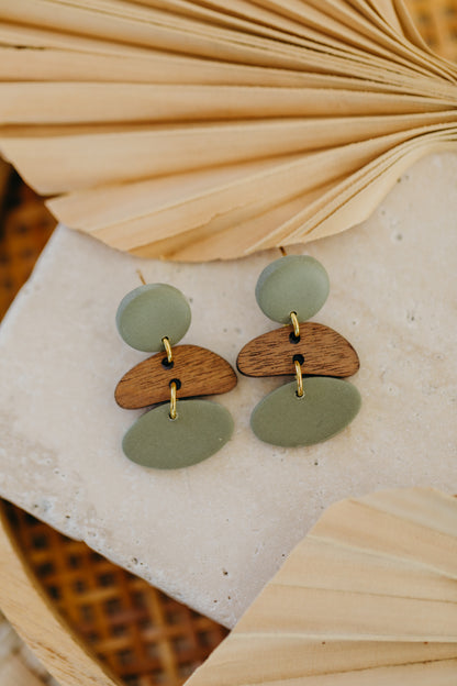 triangular polymer clay earrings in eucalyptus green with rectangular wooden pendant