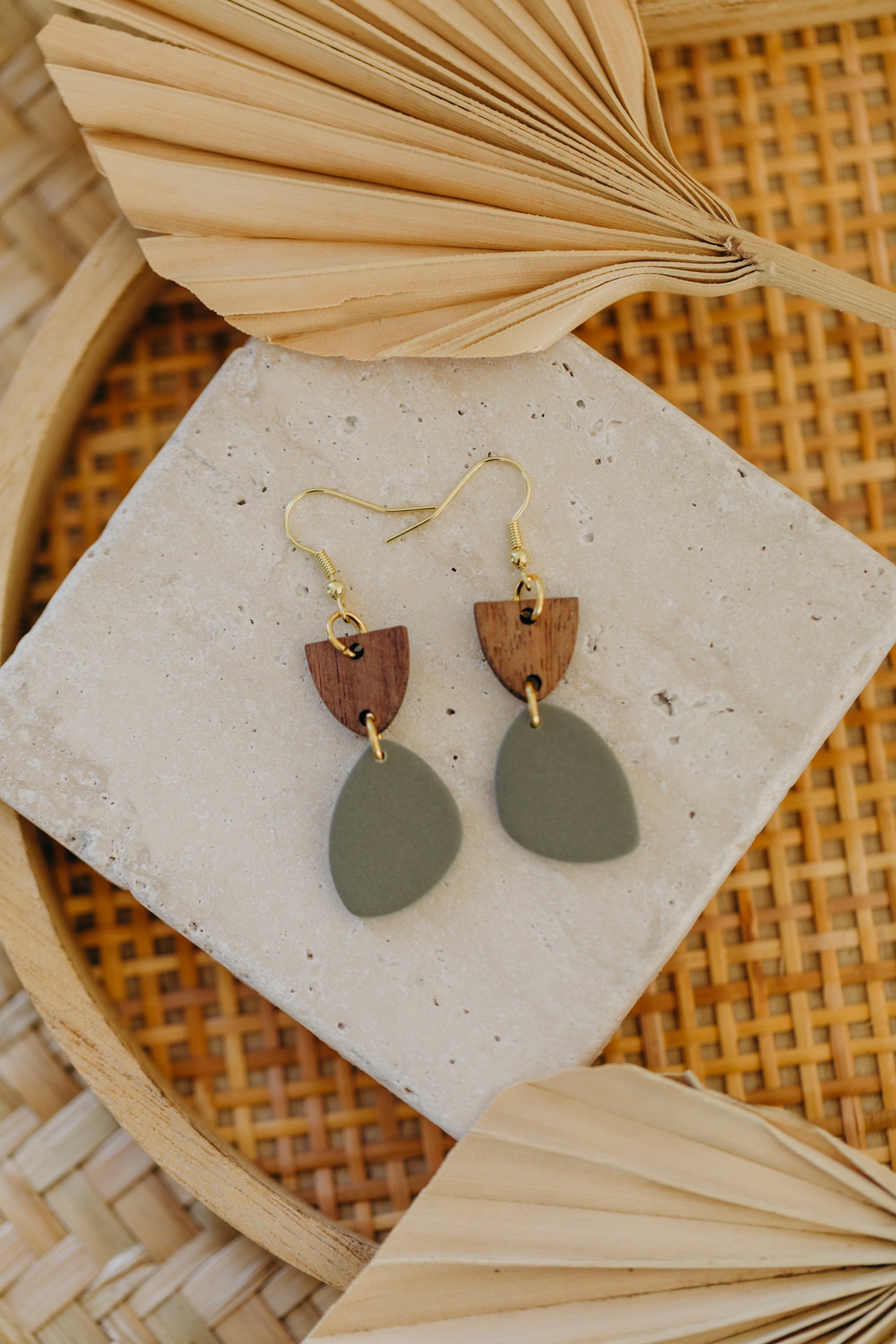 triangular polymer clay earrings in eucalyptus green with rectangular wooden pendant