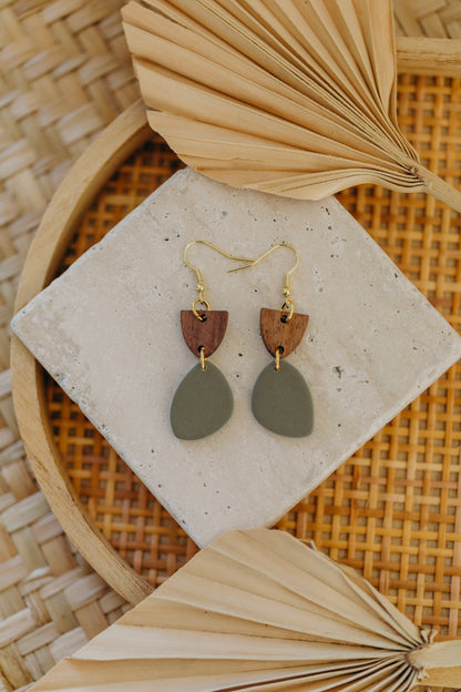 triangular polymer clay earrings in eucalyptus green with rectangular wooden pendant