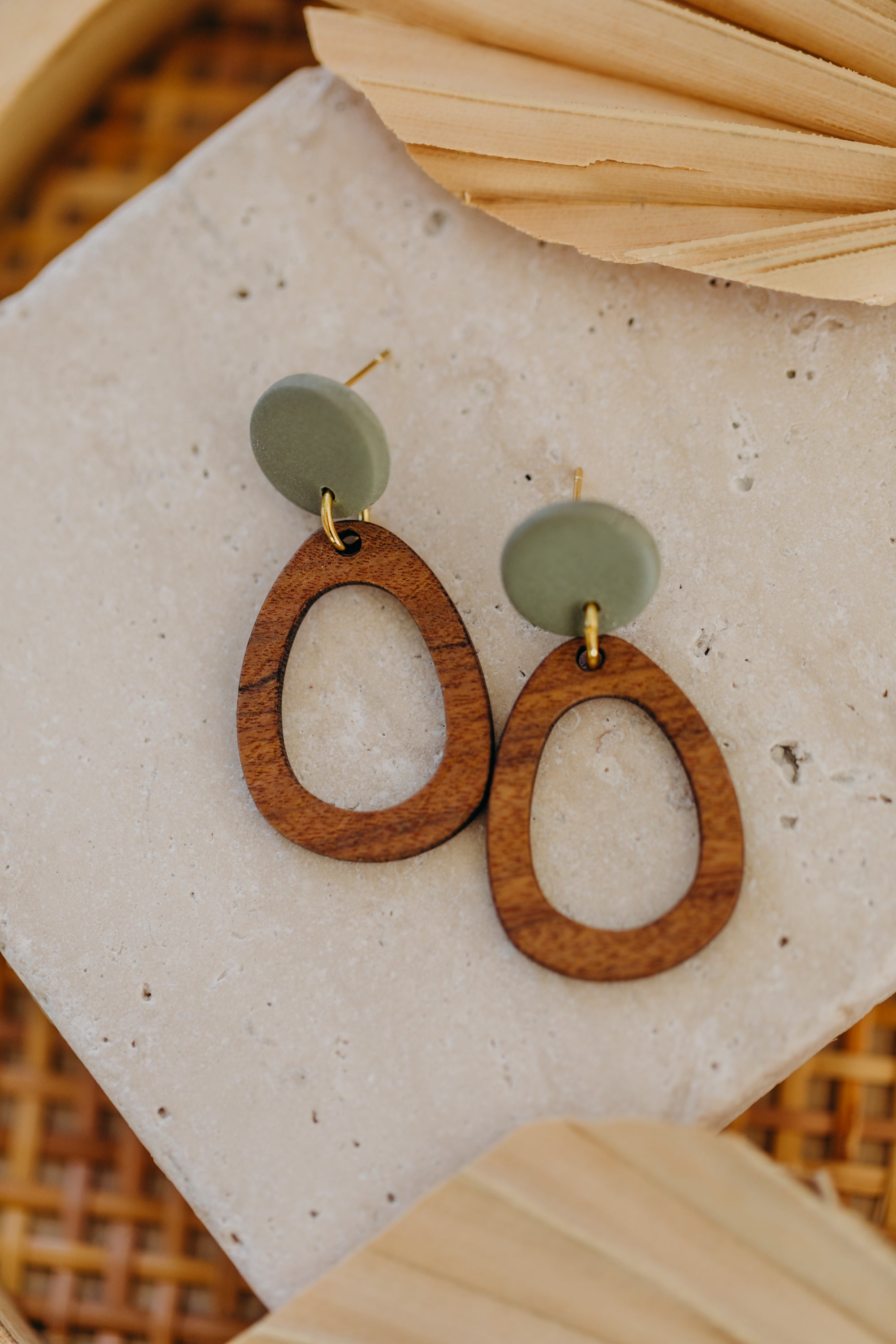 triangular polymer clay earrings in eucalyptus green with rectangular wooden pendant