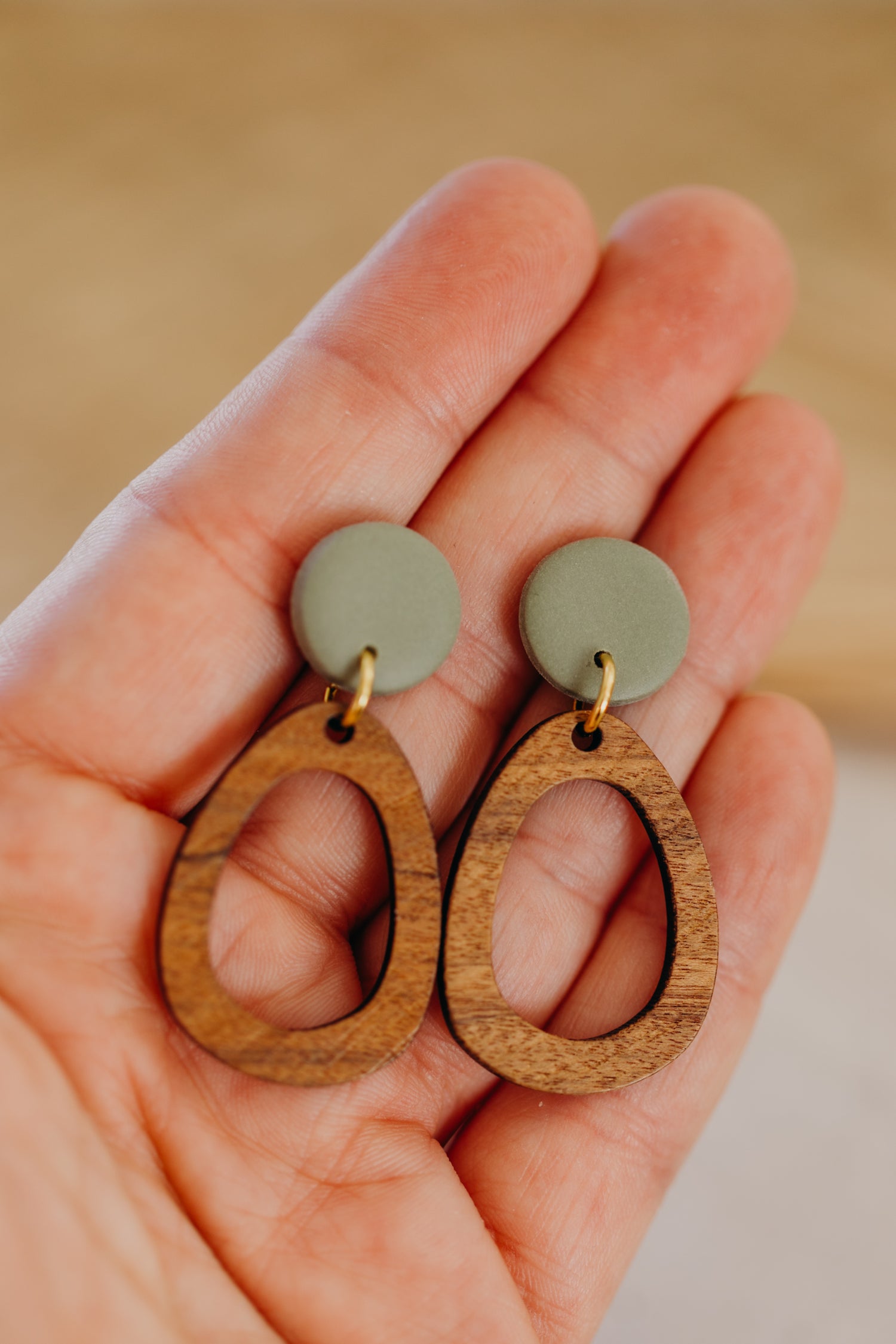 triangular polymer clay earrings in eucalyptus green with rectangular wooden pendant